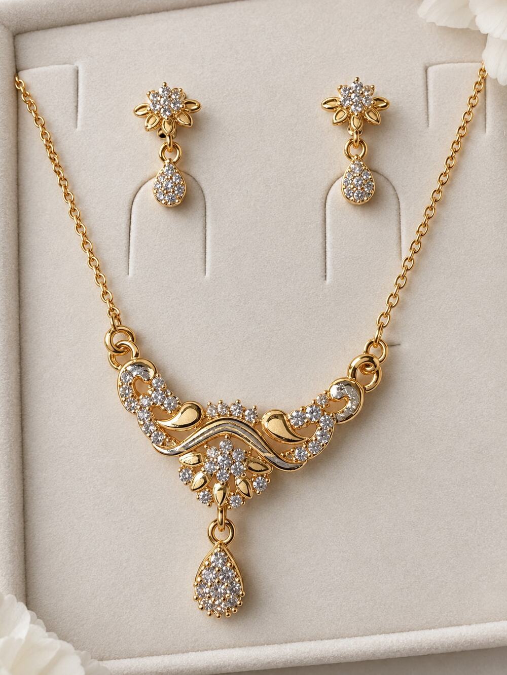gold plated CZ floral necklace and earrings set with sparkling accents
